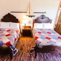 Two Full Beds and Nightstand in Room 2